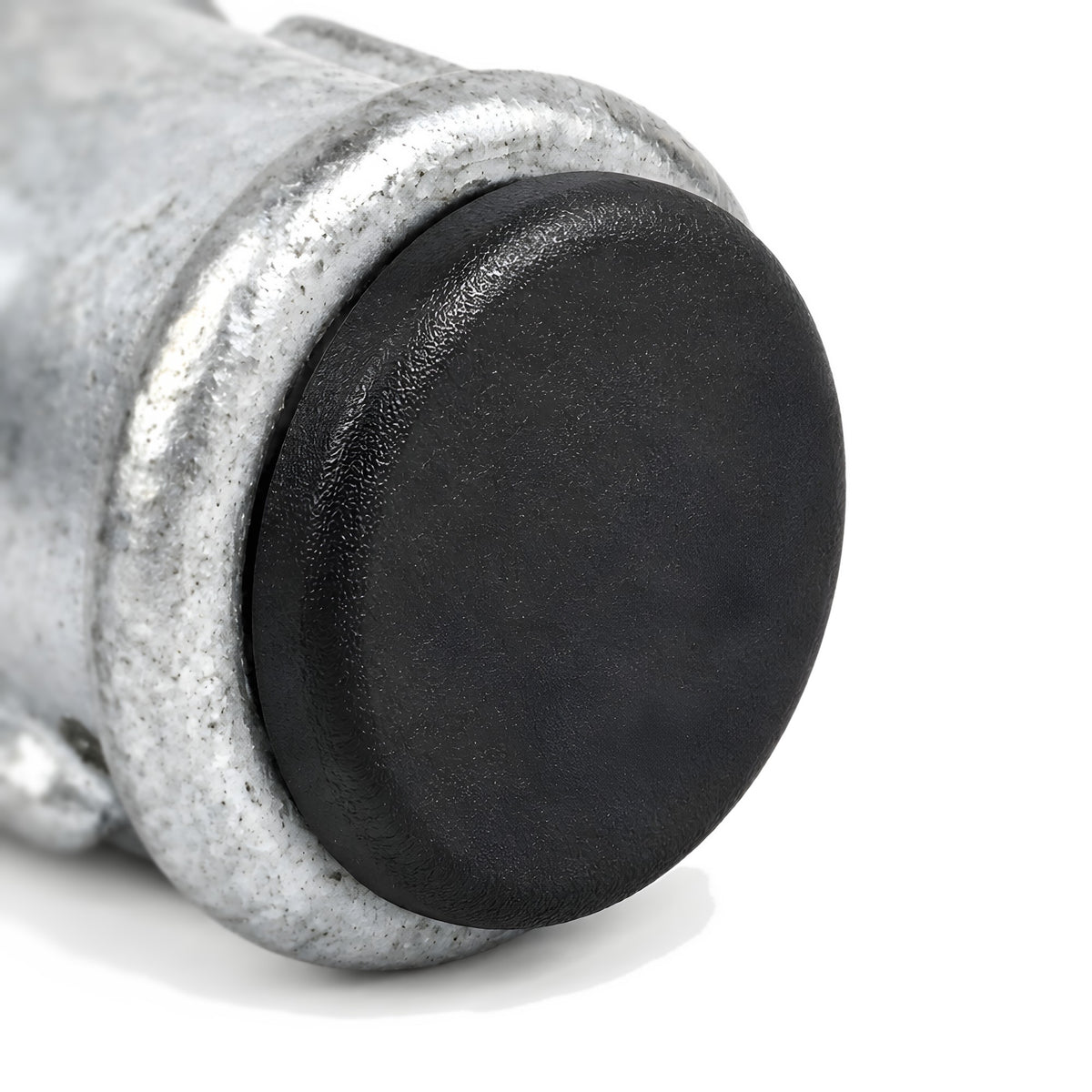 Black plastic insert closing the opening of a galvanized cast iron coupling