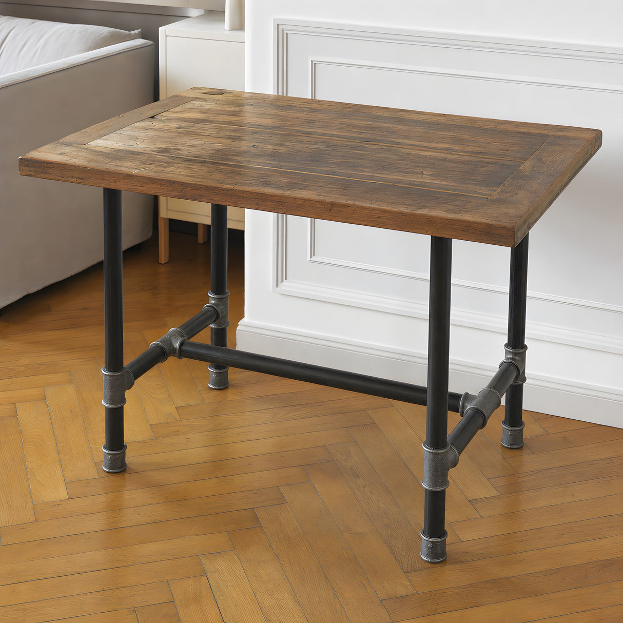 H-frame dining table base, cast iron and varnished steel Ø 42 mm, shown in a room under a tabletop made from an old wooden door