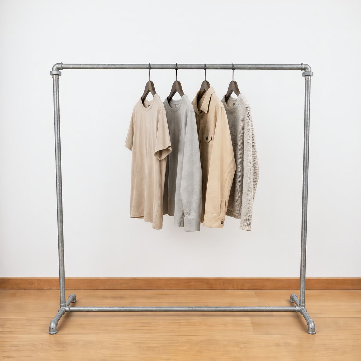 Galvanized industrial clothing rack loaded with clothes on hangers