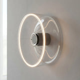 E27 LED donut bulb in clear glass, Ø 195 mm, as a wall light with a warm halo of light