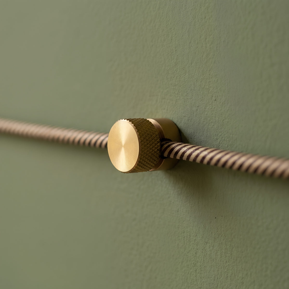 Metal wall-mount cable clip for fabric cable — Satin bronze
