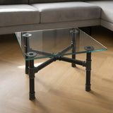 Cross-leg coffee table base, cast iron and varnished steel Ø 34 mm, shown in a room under a tempered glass tabletop