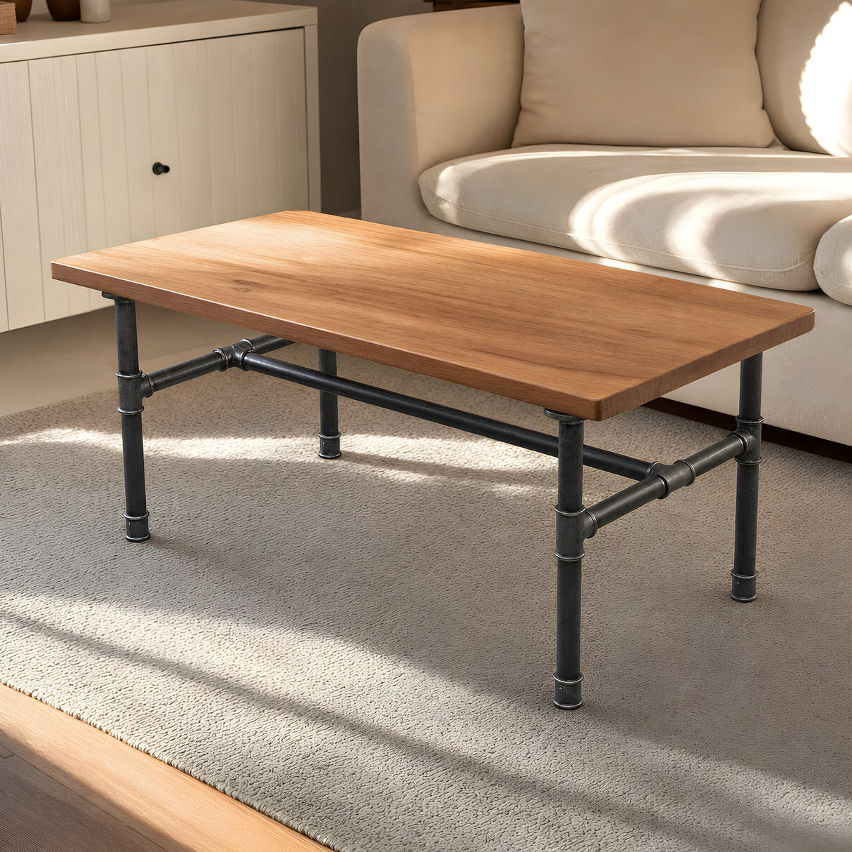 H-frame coffee table base, cast iron and varnished steel Ø 27 mm, shown in a room under an oiled teak tabletop