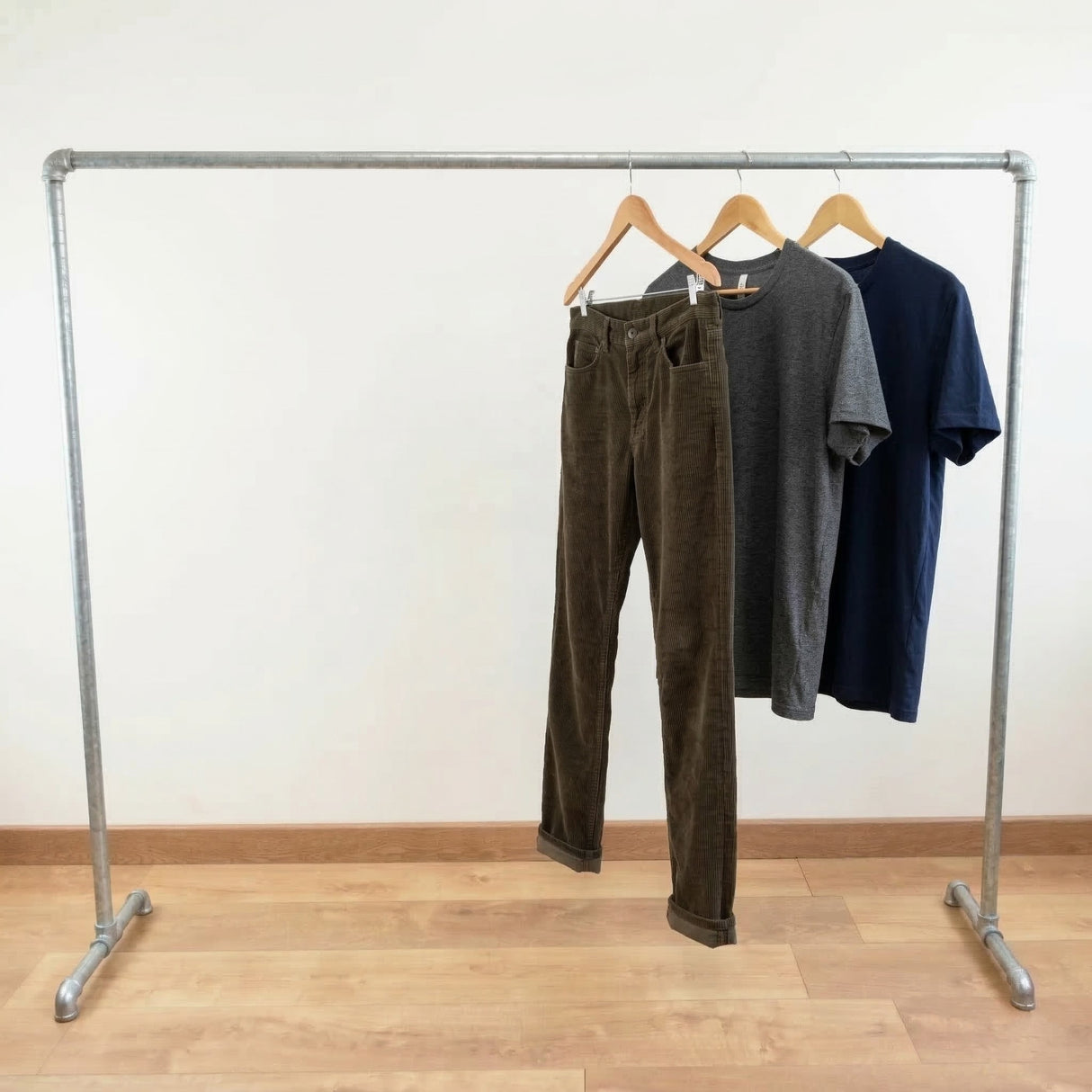 Galvanized rack loaded with clothes on hangers