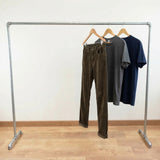 Galvanized rack loaded with clothes on hangers