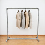 Galvanized industrial clothing rack loaded with clothes on hangers