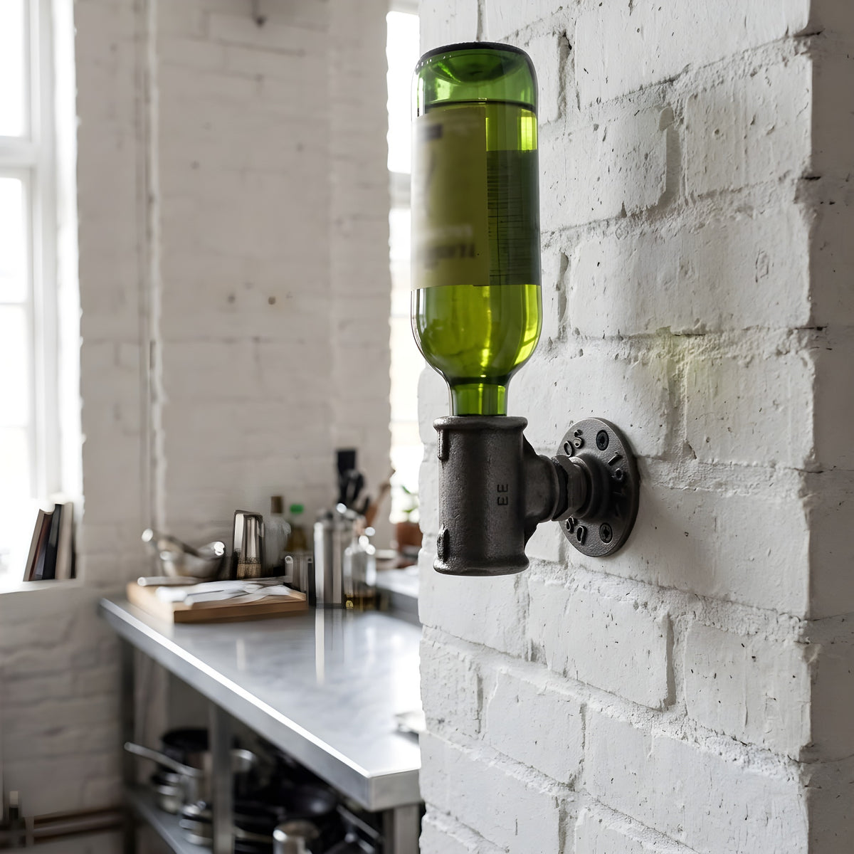 Cast iron wall bottle holder mounted on a white-painted brick wall in an industrial kitchen, wine bottle held by the neck