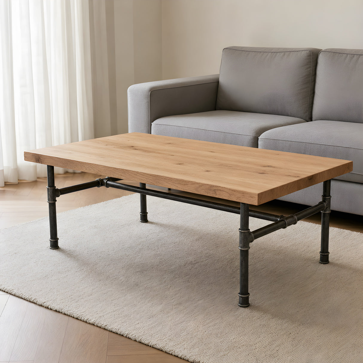Industrial coffee table with light oak top on cast iron H-frame base, lifestyle scene (top not included)