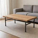Industrial coffee table with light oak top on cast iron H-frame base, lifestyle scene (top not included)