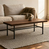 Coffee table with walnut top on cast iron H-frame base in a living room, lifestyle scene (top not included)