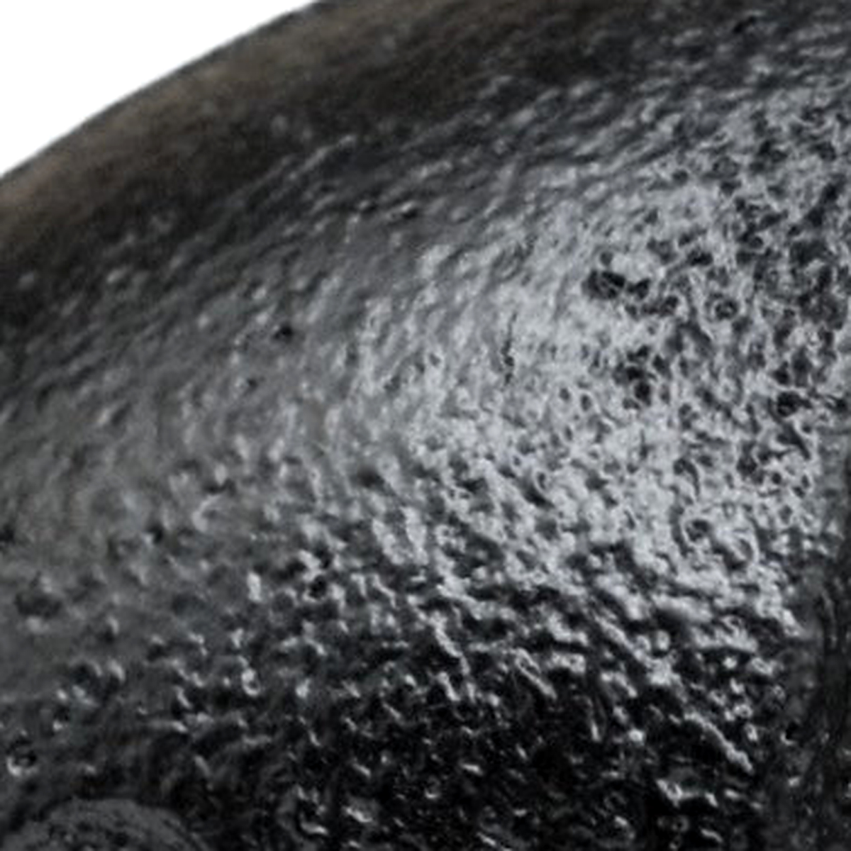 Close-up of the matte, grainy black paint on a cast iron fitting